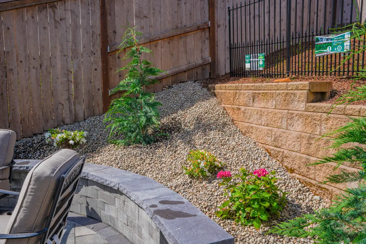 Backyard with retaining wall and plantings by CreekView Landscape in Oregon