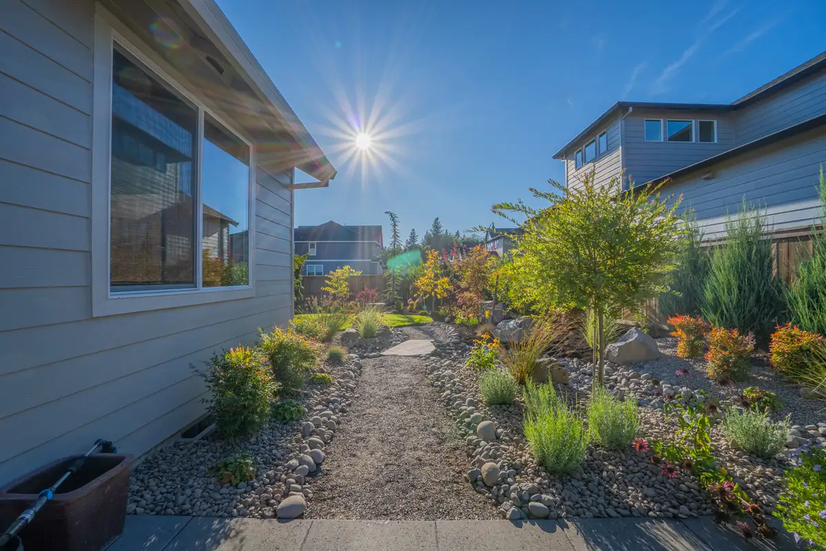 Side yard gravel path landscape design by CreekView Landscape in Oregon