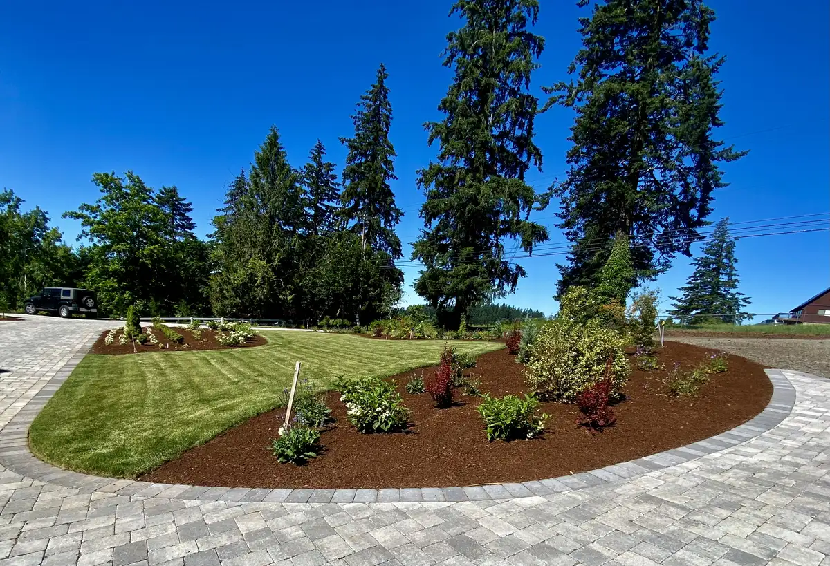 Circular paver driveway with landscape island by CreekView Landscape