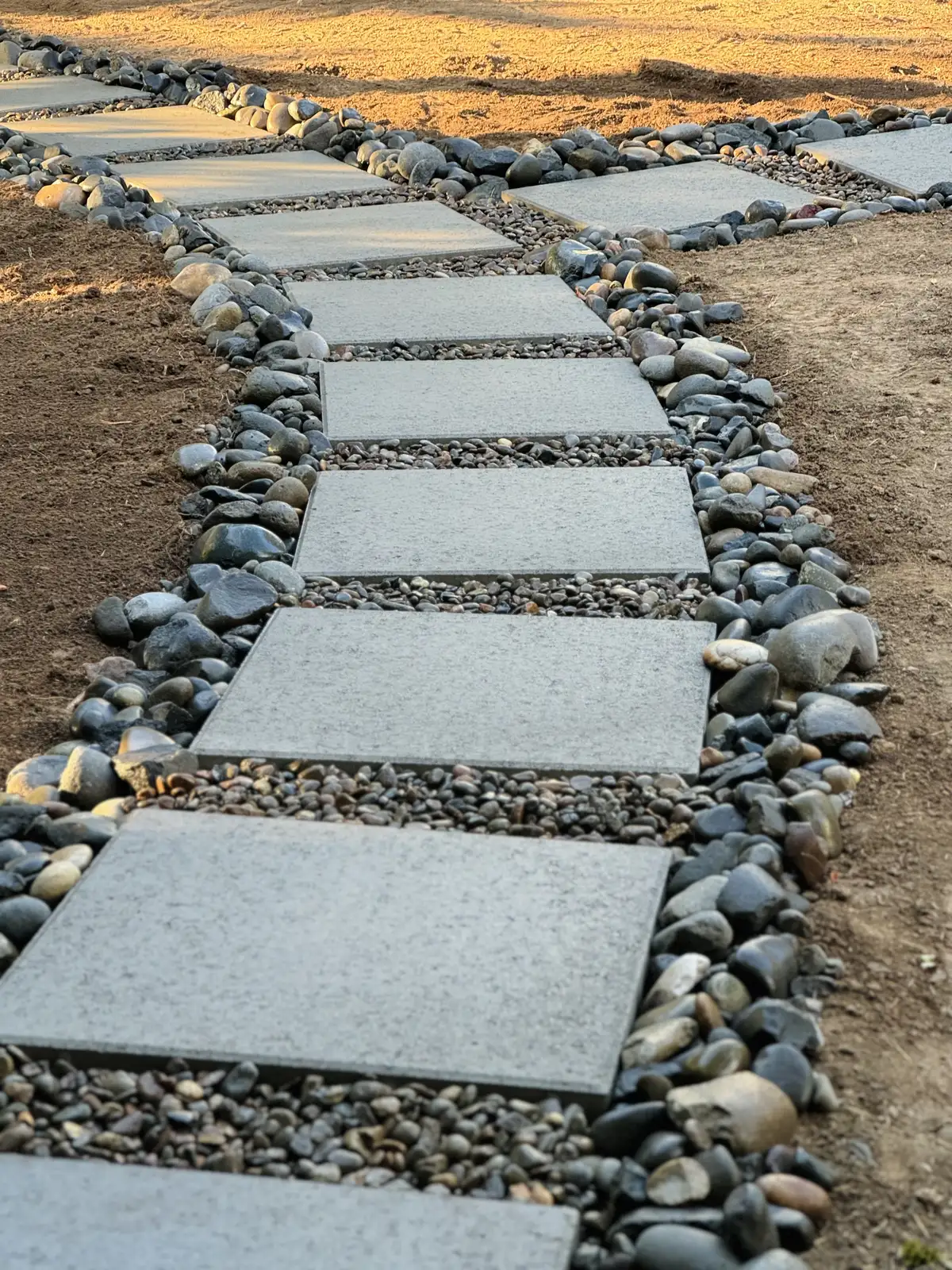 Stepping stone walkway in river rock by CreekView Landscape in Oregon